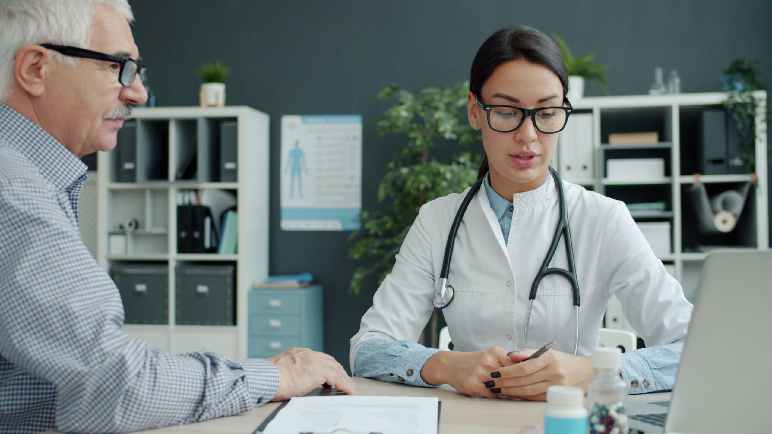 Older adult discussing health care with a medical professional